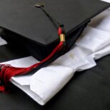graduation-cap-and-gown-attire-in-black-and-white--BTPWYX7