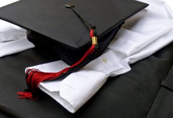 graduation-cap-and-gown-attire-in-black-and-white--BTPWYX7